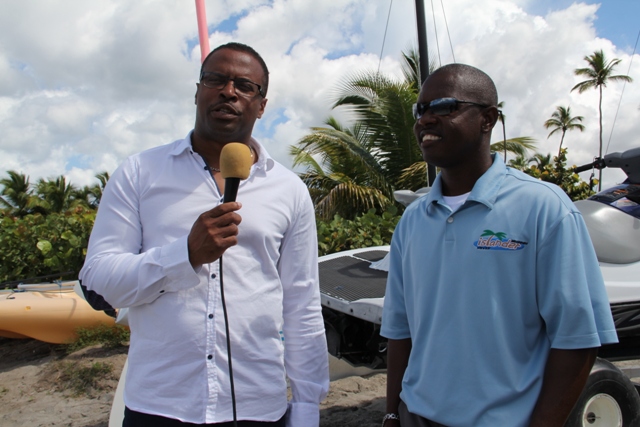 (L-R) Deputy Premier of Nevis and Minister of Tourism Hon. Mark Brantley speaks to proprietor of Islander Water Sports on Pinneys Beach Wincent Perkins during a field trip on March 04, 2014